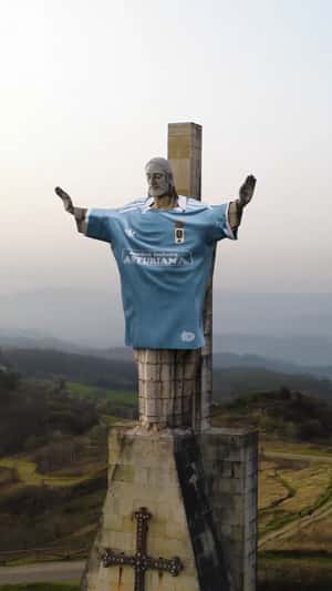 Giant Jersey Worn by El Cristo Statue in a fake-out-of-home ad of Real Oviedo