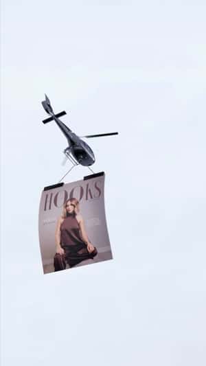 Giant Cover Airlifted by Helicopter in a fake-out-of-home ad of Hooks Magazine