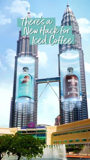 Towers Open to Reveal Giant Coffee Bottles in a fake-out-of-home ad of Nescafé