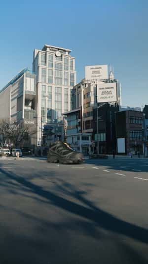Giant Shoe Glides Through City in a fake-out-of-home ad of Salomon