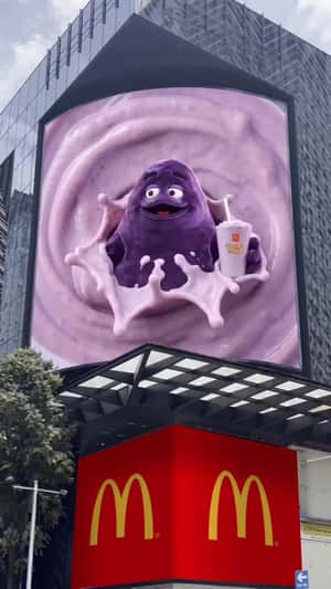 McDonald’s Grimace Pops Out of Billboard in a fake-out-of-home ad of McDonald's