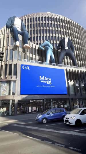 Giant Denim Outfits Dance on Building Top in a fake-out-of-home ad of C&A