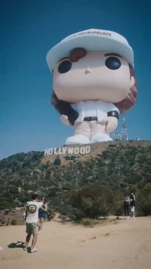Giant Dustin Funko Pop on Hollywood Hill in a fake-out-of-home ad of Kinder