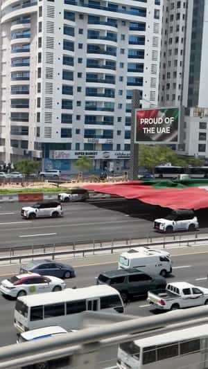 Nissan Cars Pull Giant UAE Flag on Highway in a fake-out-of-home ad of NIssan