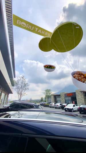 Giant Bowls Land by Parachute in a fake-out-of-home ad of Boru