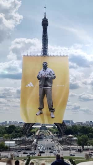 Giant Banner Hangs From Eiffel Tower in a fake-out-of-home ad of Adidas