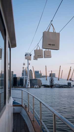 Giant Shopping Bags Travel on Cable Wires in a fake-out-of-home ad of ME+EM
