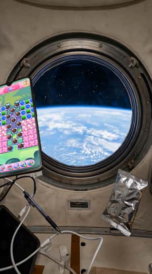 Floating Phone With Game in Space in a fake-out-of-home ad of Candy Crush