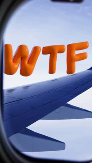 Giant WTF Balloons Float Above Airplane in a fake-out-of-home ad of Kayak