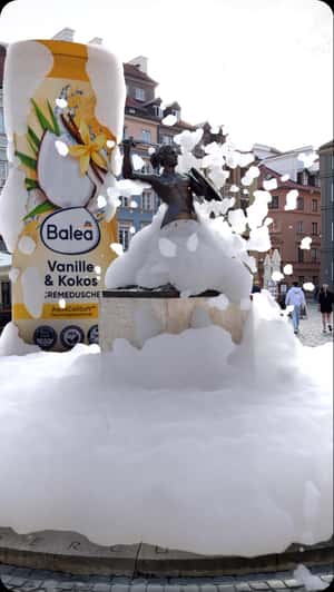 Giant Bottle Floods Mermaid Statue With Suds in a fake-out-of-home ad of DM