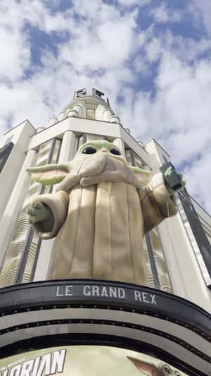 Floating Popcorn Flies Toward Giant Grogu in a fake-out-of-home ad of Disney