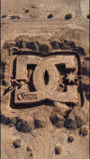 Giant DC Logo Carved Into Ground in a fake-out-of-home ad of Nitro Circus