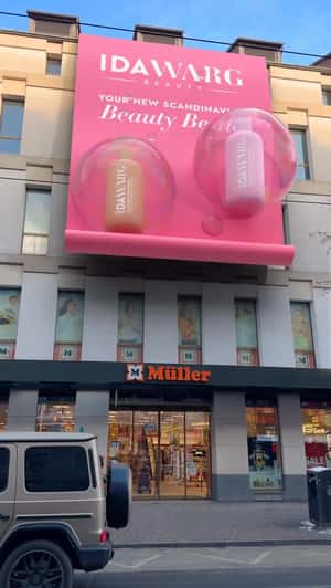 Products Float From Giant Banner in a fake-out-of-home ad of IDA WARG Beauty