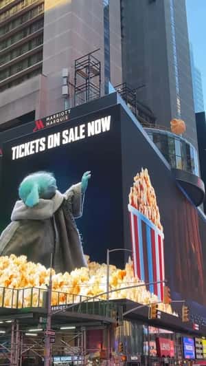 Giant Popcorn Floats Toward Grogu in a fake-out-of-home ad of Star Wars