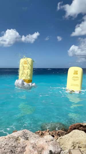 Clay And Glow Giant Sunscreens Emerge From Sea in a fake-out-of-home ad of Clay and Glow