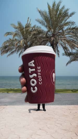 Employee Extends Elastic Arm With Coffee in a fake-out-of-home ad of Costa Coffee