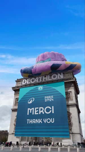 Giant Purple Hat Crowns Arc de Triomphe in a fake-out-of-home ad of Decathlon