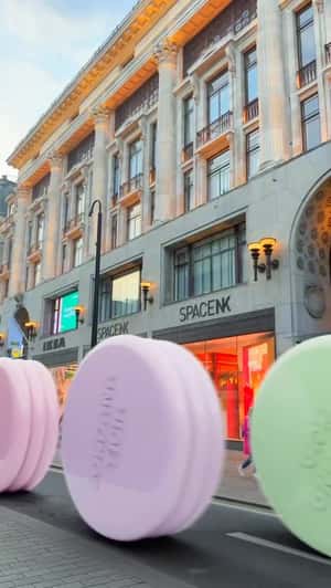 Giant Compacts Roll Past Store in a fake-out-of-home ad of Jordana Ticia