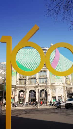 Giant Birthday Cake Emerges From Building in a fake-out-of-home ad of Printemps