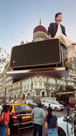JBL Speaker Rises and Giant Man Sitting in fake-out-of-home ad of JBL