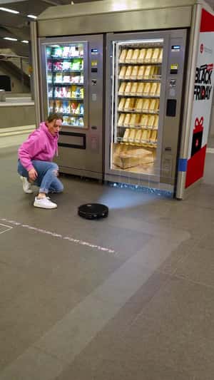 Black Vacuum Pushes Gold Bars in fake-out-of-home ad of Roborock