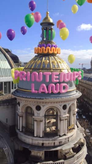Colorful Balloons Float at Tower in Fake-out-of-home ad of Printemps