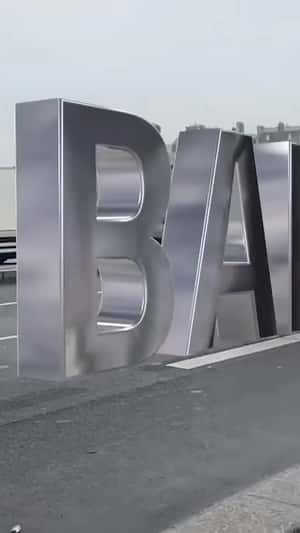 Balenciaga Metallic Letter Standees in a fake-out-of-home ad of Balenciaga