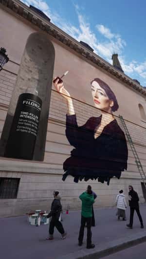 Serum Applied to Woman’s Face on Painting in fake-out-of-home ad of Filorga