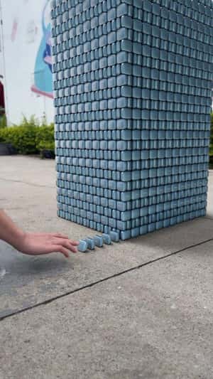 Earbuds Jenga Blocks Tower in fake-out-of-home ad of OnePlus