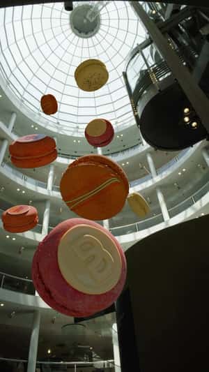 Floating Colorful Macarons in a fake-out-of-home ad of Breuninger