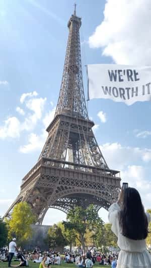 “WE'RE WORTH IT” banner on Eiffel Tower fake-out-of-home ad of L'Oréal Paris
