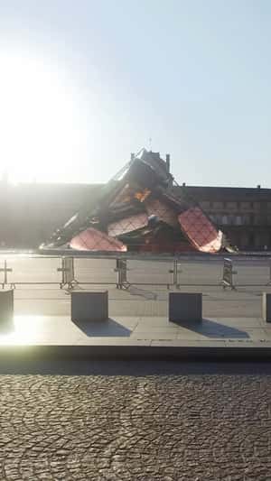 Bags Float in Glass Pyramid in fake-out-of-home ad of Victoria Beckham