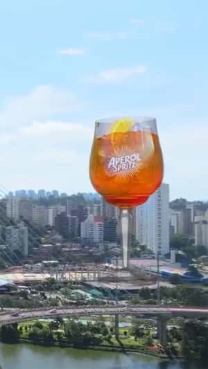 Towering Wine Glass skyline in fake-out-of-home ad of Aperol Spritz