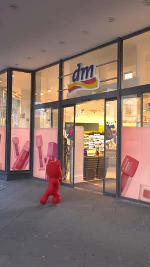 Pink Teddy Shops Lip Tint in a fake-out-of-home ad of Maybelline