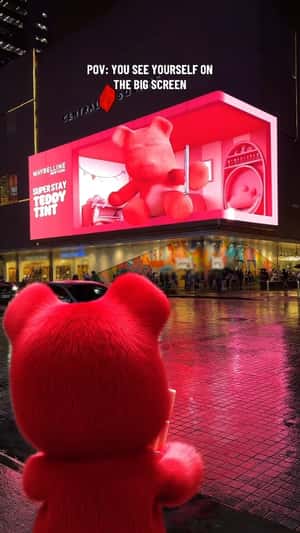Pink Teddy Holding Lip Tint in a fake-out-of-home ad of Maybelline