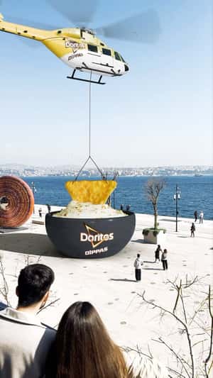 Chip Dipped In Sauce By Helicopter in fake-out-of-home ad of Doritos