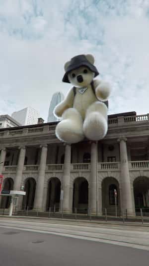 Teddy Bear Sits Above Building in a fake-out-of-home ad Prada