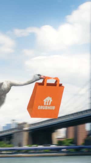Orange Bag Delivery by Storks in a fake-out-of-home ad Grubhub