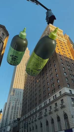 Bottle-shaped Balloons Float in fake-out-of-home ad of Graza