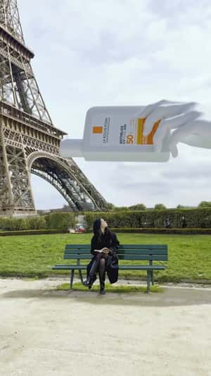 Giant La Roche-Posay covering woman in Paris fake-out-of-home ad of L'Oréal Paris
