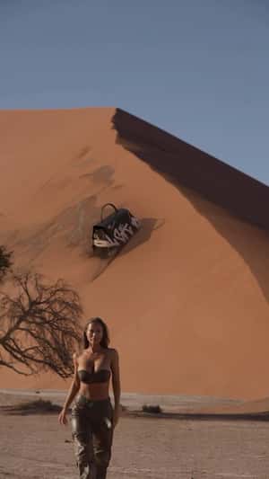 Graffiti bag skiing on sand in fake-out-of-home ad of A Quick Buck