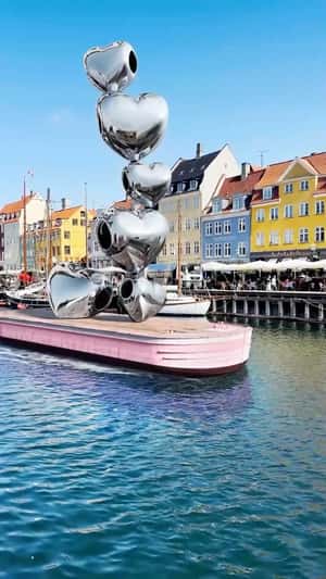 Piled Heart Charms on Boat in fake-out-of-home ad of Pandora