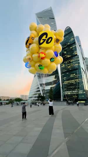 Man Lifted by Yellow Balloons in fake-out-of-home ad of Yandex Go