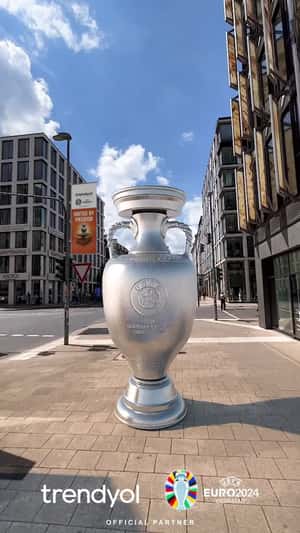 Football Trophy Stands on the Sidewalk in a fake-out-of-home-ad of Trendyol