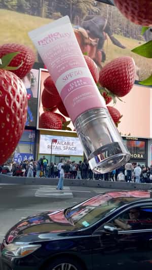 Giant strawberries and SPF product in Hello Sunday fake-out-of-home ad of Sephora