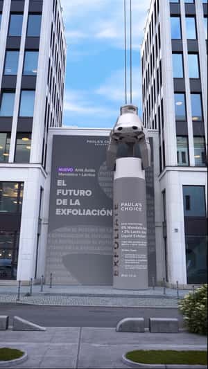 Exfoliate Bottle Carried by Crane in fake-out-of-home promotional ad of Paula’s Choice