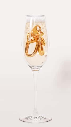 Jewelries Sparkle Inside Champagne Glass in fake-out-of-home ad of Hey Harper