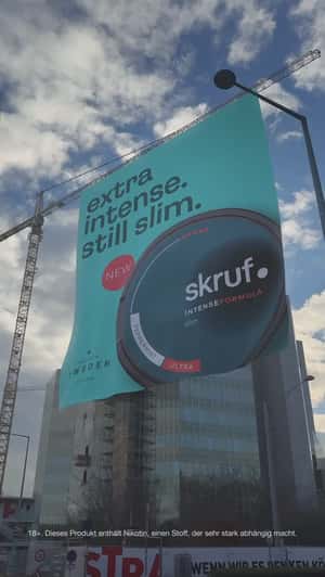 Poster Rolls Down From a Crane in fake-out-of-home ad of Skruf