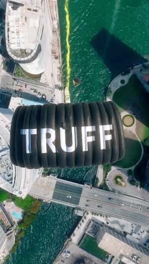Green Figure on Parachute Spills Green Smoke in fake-out-of-home ad of TRUFF