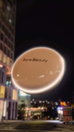 Rare Beauty Positive Light Silky Touch Highlighter resembling a UFO fake-out-of-home ad of Sephora